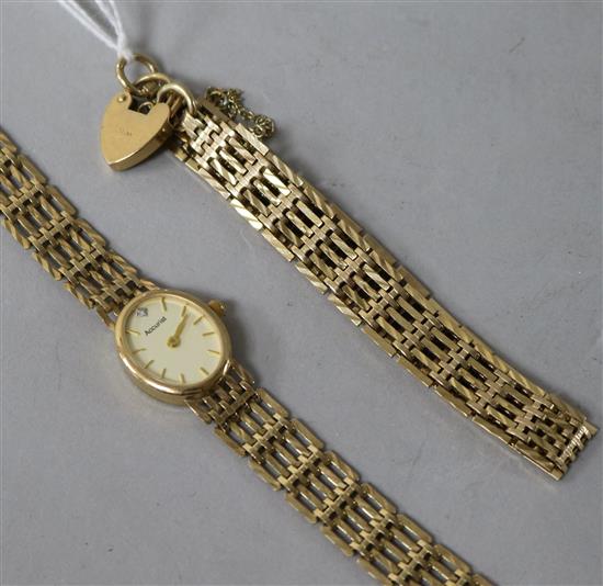 A 9ct gold wristwatch on gatelink bracelet, a similar bracelet with padlock clasp and a pair of earrings.